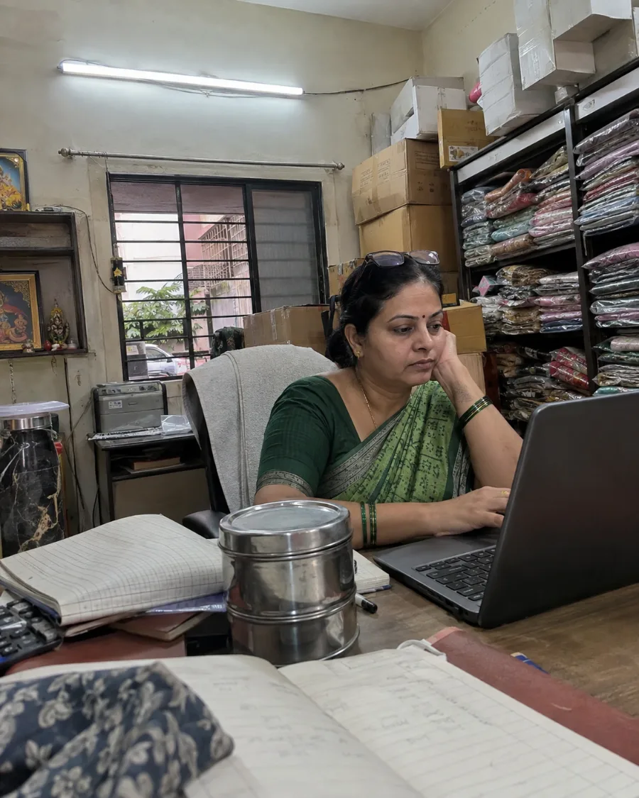 The shop owner reading the evening review on her laptop.